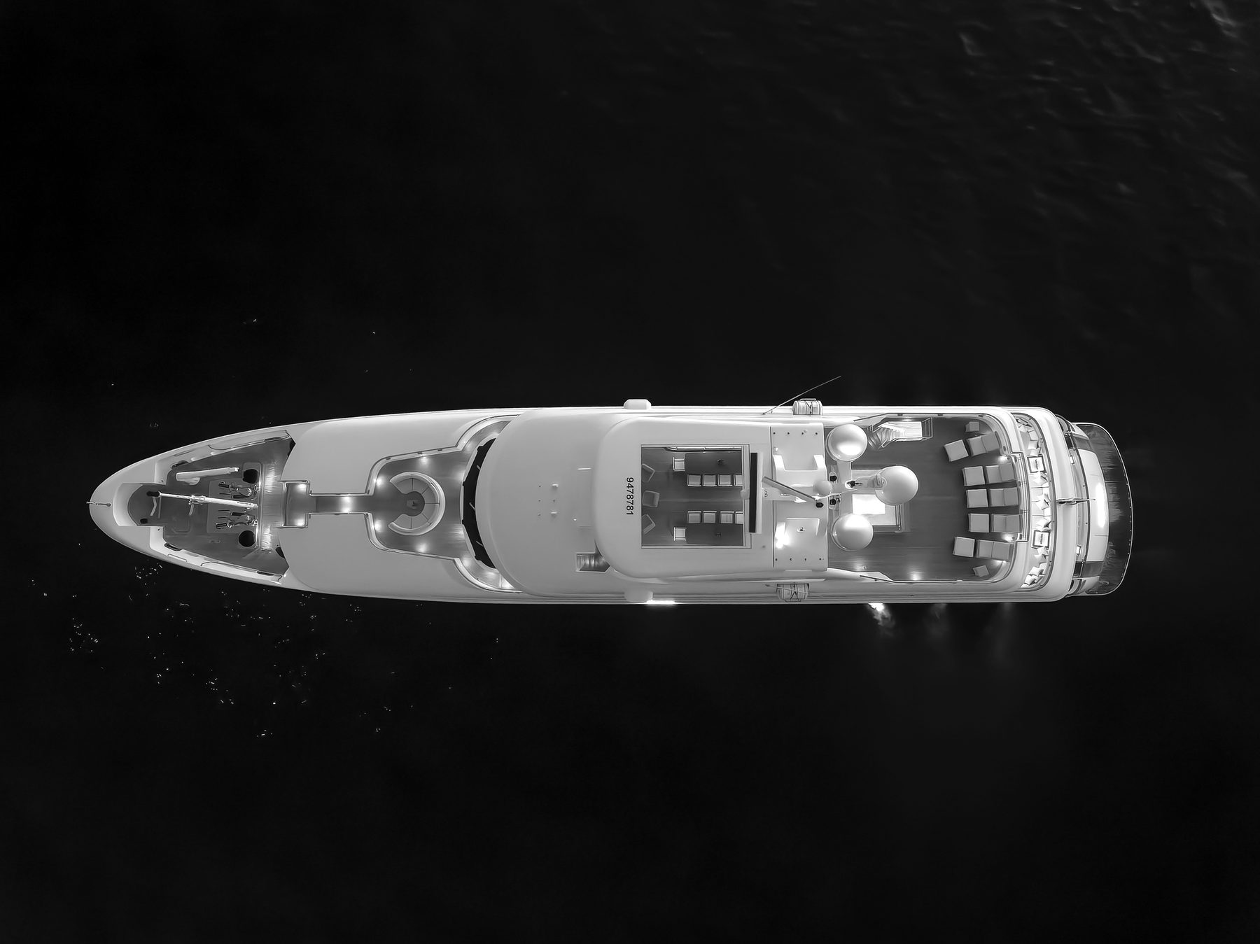 Overhead aerial of a superyacht's decks at anchor
