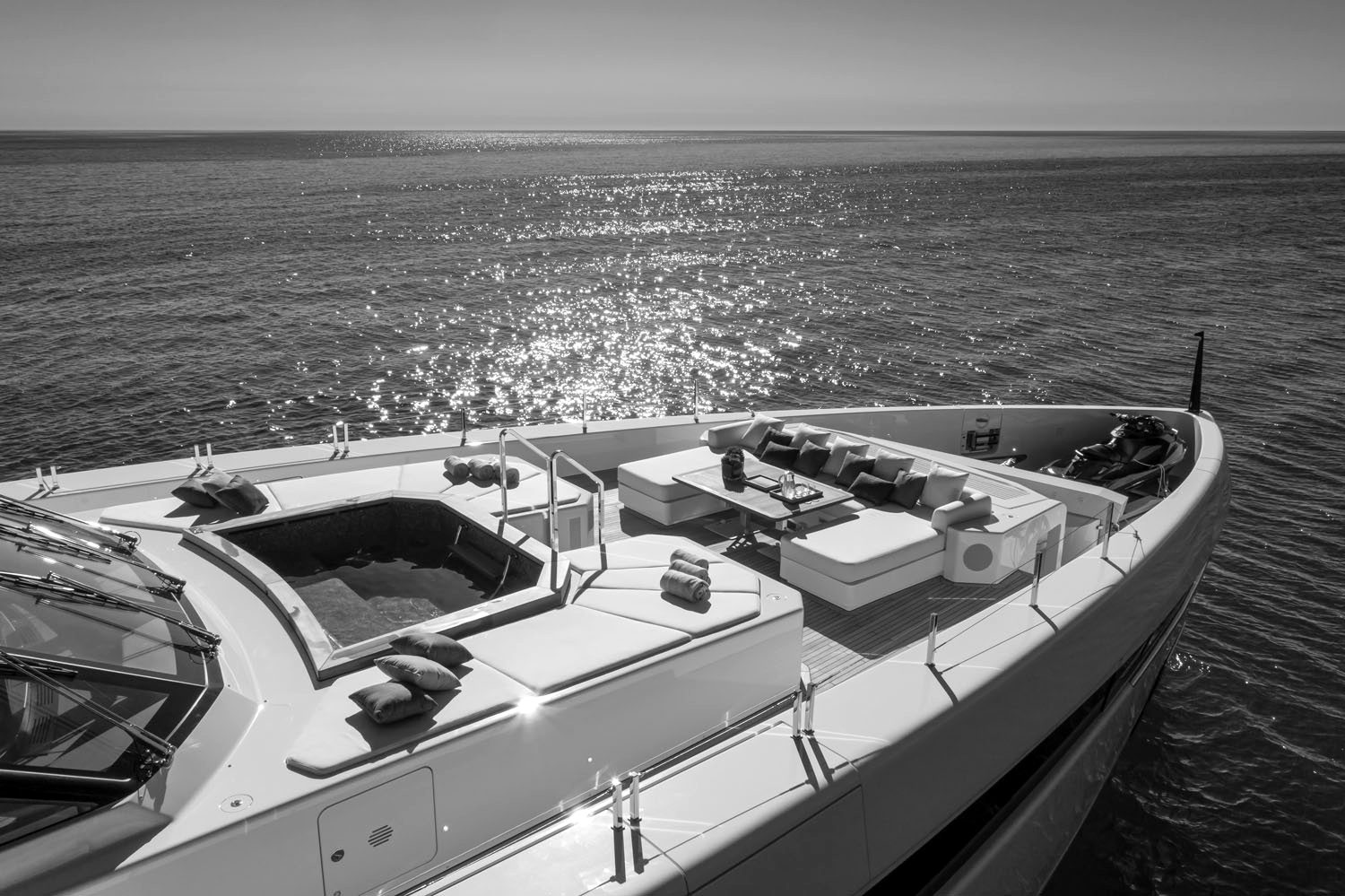 A superyacht foredeck with a spa pool and seating, seen from above