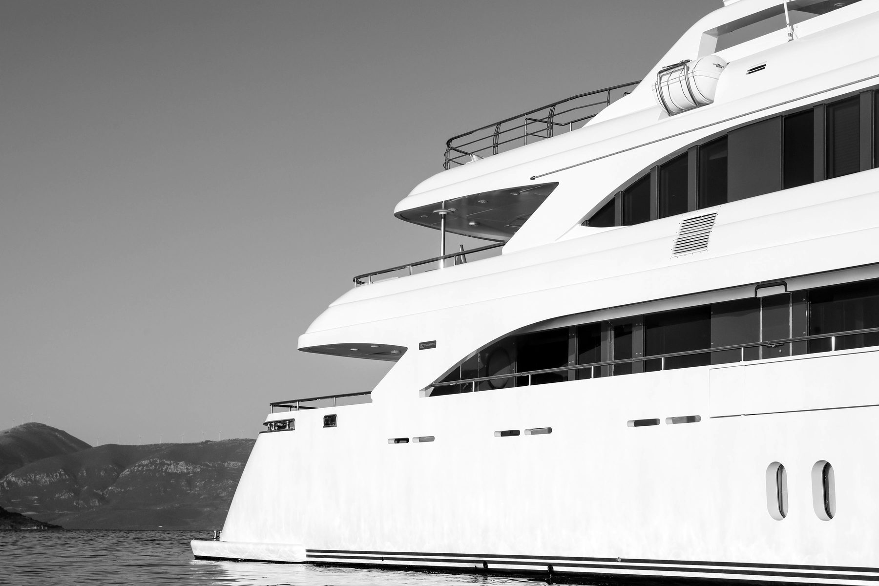 Profile of a white motor superyacht with multiple decks