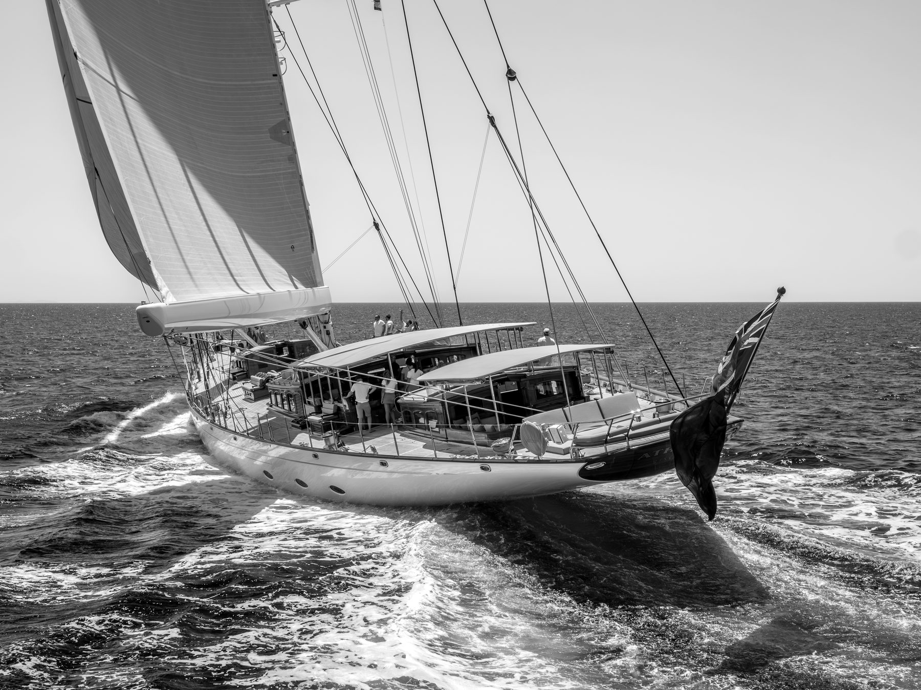 A classic sailing superyacht under full sail heeling through open water