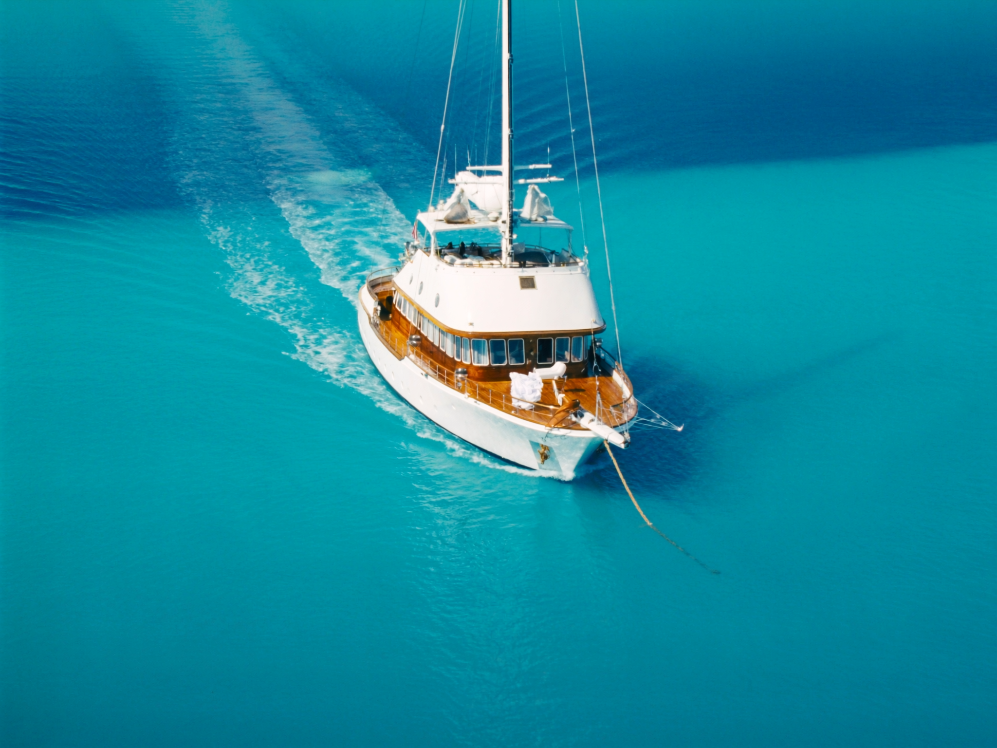A classic explorer superyacht anchored over turquoise Caribbean water